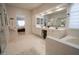 Elegant primary bathroom with double vanity, soaking tub, and tiled floors at 1132 E Sheffield Ave, Chandler, AZ 85225