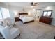 Bright main bedroom boasts a king bed, seating area, and an ensuite bathroom at 1132 E Sheffield Ave, Chandler, AZ 85225