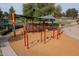 View of the community playground with swings, a slide and covered seating area at 1132 E Sheffield Ave, Chandler, AZ 85225