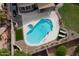 Aerial view of a backyard pool featuring a connected hot tub, seating and privacy at 1132 E Sheffield Ave, Chandler, AZ 85225