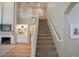 Staircase with carpet and large clock on wall with views of fireplace and shelving in living room at 1132 E Sheffield Ave, Chandler, AZ 85225