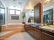 Bright bathroom featuring a soaking tub, vanity with a marble countertop, and a glass shower at 114 W Adams St # Ph, Phoenix, AZ 85003