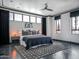 Serene main bedroom with a plush bed, contemporary decor, and large windows providing natural light at 114 W Adams St # Ph, Phoenix, AZ 85003
