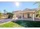 Landscaped backyard and covered patio with ceiling fans, ideal for relaxation and entertaining at 1227 E Sheena Dr, Phoenix, AZ 85022