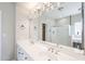 Bathroom featuring dual sink vanity with a large mirror and custom lighting at 1227 E Sheena Dr, Phoenix, AZ 85022