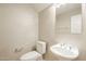 Cozy half bathroom with a pedestal sink, toilet, and mirror at 1227 E Sheena Dr, Phoenix, AZ 85022