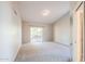 Spacious bedroom featuring neutral walls, carpet flooring, and a sliding glass door to the patio at 1227 E Sheena Dr, Phoenix, AZ 85022