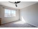 This bedroom features a large window overlooking the street, neutral paint and plush carpet at 1227 E Sheena Dr, Phoenix, AZ 85022