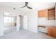 This bedroom features a ceiling fan, built-in desk and mirrored closet, and neutral paint and carpet at 1227 E Sheena Dr, Phoenix, AZ 85022