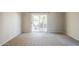 Bright bedroom with neutral walls, carpet flooring, and access to the patio at 1227 E Sheena Dr, Phoenix, AZ 85022