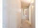 Bright hallway featuring neutral carpet and white walls, illuminated by sconce lighting at 1227 E Sheena Dr, Phoenix, AZ 85022