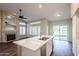 Bright kitchen features an island with bar seating, stainless steel appliances, and open to the living room at 1227 E Sheena Dr, Phoenix, AZ 85022