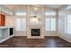Bright living room features a fireplace, modern windows with white shutters and a sleek dark wood floor at 1227 E Sheena Dr, Phoenix, AZ 85022