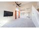 Spacious carpeted living room with tall ceilings, large windows, and staircase at 1227 E Sheena Dr, Phoenix, AZ 85022