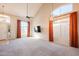 Bright living room with tall ceilings, many windows with curtains, and ceiling fan at 1227 E Sheena Dr, Phoenix, AZ 85022