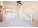 Spacious carpeted living room with tall ceilings and staircase at 1227 E Sheena Dr, Phoenix, AZ 85022