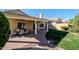 Covered brick patio with view of manicured lawn and home's exterior at 1227 E Sheena Dr, Phoenix, AZ 85022