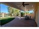 Covered brick patio with ceiling fans, overlooking manicured landscaping and golf course views at 1227 E Sheena Dr, Phoenix, AZ 85022