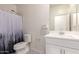 Well-lit bathroom with a modern vanity, and a stylish shower curtain for privacy at 12565 W Palmaire Ave, Glendale, AZ 85307