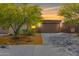 Inviting single-Gathering home with a 2-car garage, complemented by desert landscaping and a picturesque sunset backdrop at 12565 W Palmaire Ave, Glendale, AZ 85307