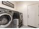 Efficient laundry area featuring modern machines and ample storage, ideal for home management at 12565 W Palmaire Ave, Glendale, AZ 85307