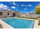 Inviting pool with surrounding turf and a patio area, perfect for outdoor gatherings at 12565 W Palmaire Ave, Glendale, AZ 85307