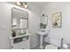 Bright bathroom with classic pedestal sink, stylish mirror, and neutral decor at 1306 W Heatherbrae Dr, Phoenix, AZ 85013