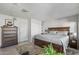Bedroom with a large bed, dresser, and neutral decor at 1306 W Heatherbrae Dr, Phoenix, AZ 85013