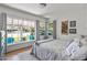 Bright bedroom featuring a large window with an outside view and light-colored walls at 1306 W Heatherbrae Dr, Phoenix, AZ 85013