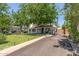 Charming single-story home with mature trees, well-manicured lawn and brick-lined driveway at 1306 W Heatherbrae Dr, Phoenix, AZ 85013