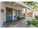 Charming covered porch with a unique front door, potted plants, and a tiled walkway leading to the entrance at 1306 W Heatherbrae Dr, Phoenix, AZ 85013
