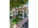 Quaint home with a tile roof, front porch, and vibrant flower beds, offering a cozy and inviting atmosphere at 1306 W Heatherbrae Dr, Phoenix, AZ 85013