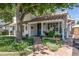 Charming home featuring a tile roof, lush landscaping, and a welcoming brick pathway leading to the front door at 1306 W Heatherbrae Dr, Phoenix, AZ 85013