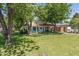 Inviting home with lush green lawn, mature trees, and a classic tile roof, creating a serene curb appeal at 1306 W Heatherbrae Dr, Phoenix, AZ 85013