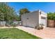 Detached garage with white facade, door and brick accents with beautiful landscaping at 1306 W Heatherbrae Dr, Phoenix, AZ 85013
