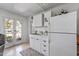 Vintage kitchen featuring white appliances, a white refrigerator, and a door to the backyard at 1306 W Heatherbrae Dr, Phoenix, AZ 85013