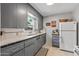 Bright kitchen with gray cabinets, white tiled countertops, and vintage charm at 1306 W Heatherbrae Dr, Phoenix, AZ 85013