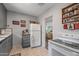 Quaint kitchen featuring white appliances, gray cabinets, and a view to the living space at 1306 W Heatherbrae Dr, Phoenix, AZ 85013