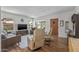 Bright living room with hardwood floors, a bay window, comfortable seating, and a modern entertainment setup at 1306 W Heatherbrae Dr, Phoenix, AZ 85013