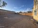 A large backyard featuring rock cover, brick wall and clear sky at 1352 S 221St Ln, Buckeye, AZ 85326