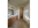 A well-lit bathroom featuring a double vanity, tiled floors, and access to walk-in closet at 1352 S 221St Ln, Buckeye, AZ 85326