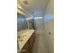 Well-lit bathroom features a bathtub with shower and single sink vanity at 1352 S 221St Ln, Buckeye, AZ 85326
