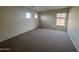 Cozy bedroom featuring plush carpet and a view through the window at 1352 S 221St Ln, Buckeye, AZ 85326