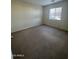 A comfortable bedroom featuring neutral walls, plush carpet and a window with blinds at 1352 S 221St Ln, Buckeye, AZ 85326