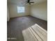 A spacious bedroom featuring neutral walls, plush carpet, a window with blinds and ceiling fan at 1352 S 221St Ln, Buckeye, AZ 85326