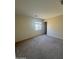 This bedroom features neutral walls, carpet, and a window to provide natural light at 1352 S 221St Ln, Buckeye, AZ 85326