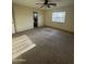 A large bedroom featuring neutral walls, plush carpet, a window with blinds and attached bathroom at 1352 S 221St Ln, Buckeye, AZ 85326