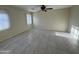 Cozy bedroom with tiled floors, ceiling fan, and bright window at 1352 S 221St Ln, Buckeye, AZ 85326