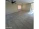 Bright living room with tiled floors and ceiling fan at 1352 S 221St Ln, Buckeye, AZ 85326