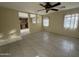 Bright living room with tiled floor, ceiling fan, and kitchen view at 1352 S 221St Ln, Buckeye, AZ 85326